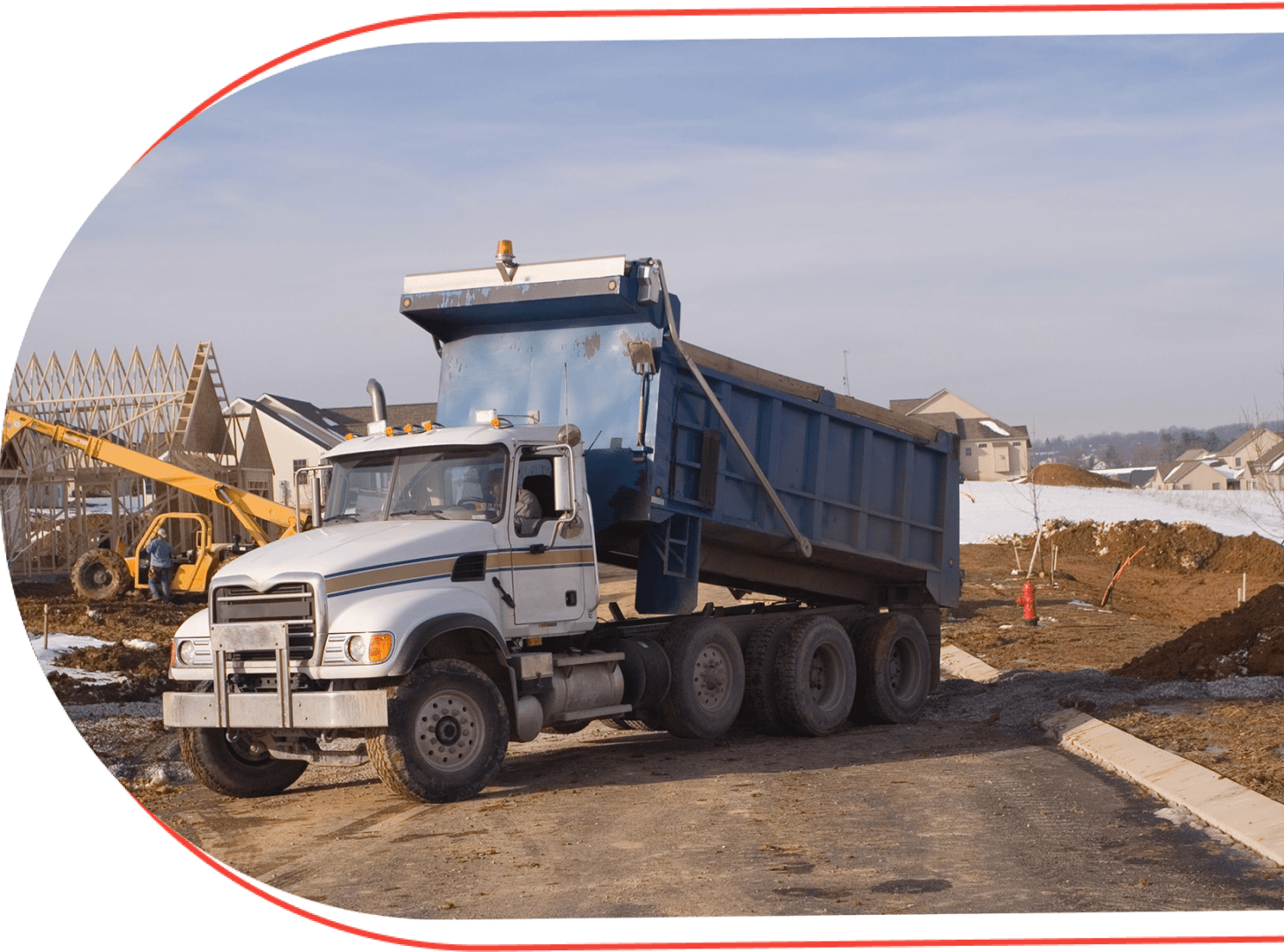 A dump truck is parked on the side of a road.